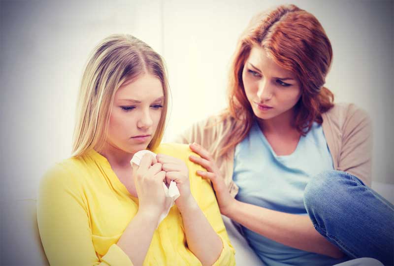 friend comforting woman during intervention