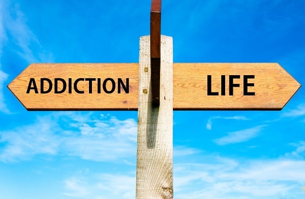 sign with addiction pointing one way and life pointing the other way