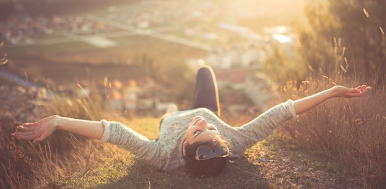person lying on back looking up at sun