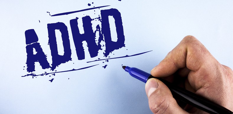 person writing ADHD on wall