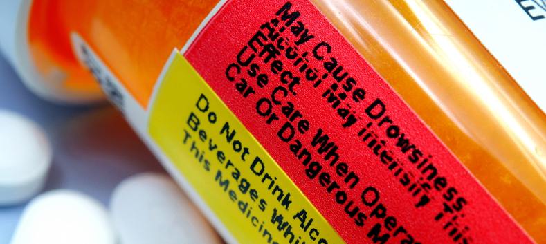 Prescription bottle with pills nearby.