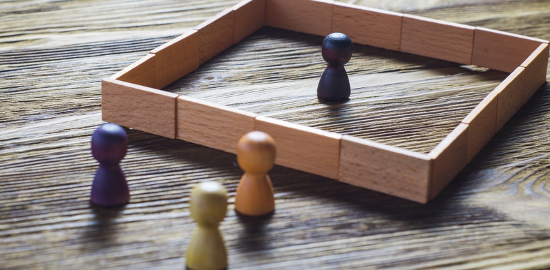 wooden game piece inside an enclosed barrier