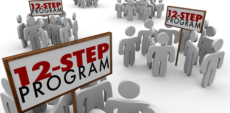 people-like cut outs holding 12-step program signs