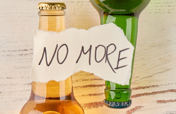 Two bottles lying on their side with a note on top stating No More.