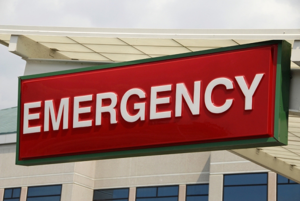 Red emergency sign with with lettering.