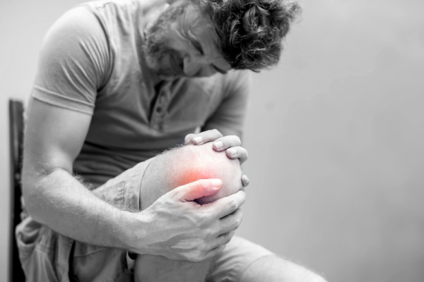 Man holding his knee in pain