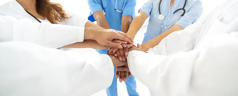 a group of medical professionals putting hands together
