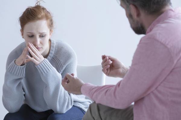 Woman sitting opposite a therapist.
