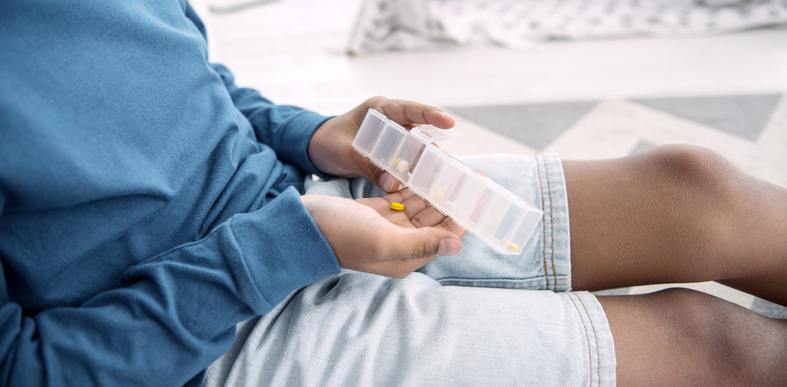 person with pill organizer