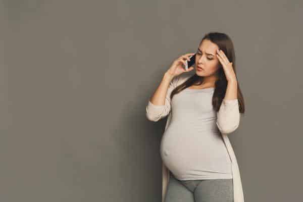 Pregnant woman talking on a phone.