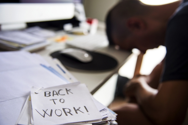 Person with their head on their desk.