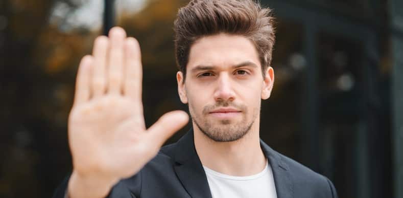 man holding his hand up signaling to stop