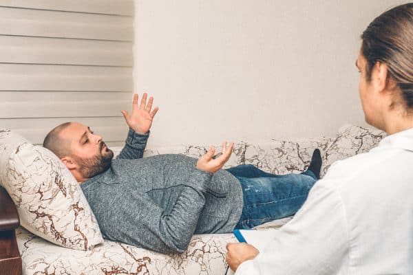 Man lying on couch during therapy session
