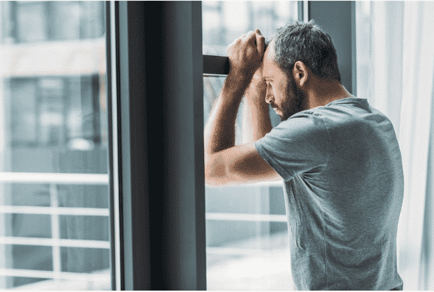 man using fentanyl staring out window