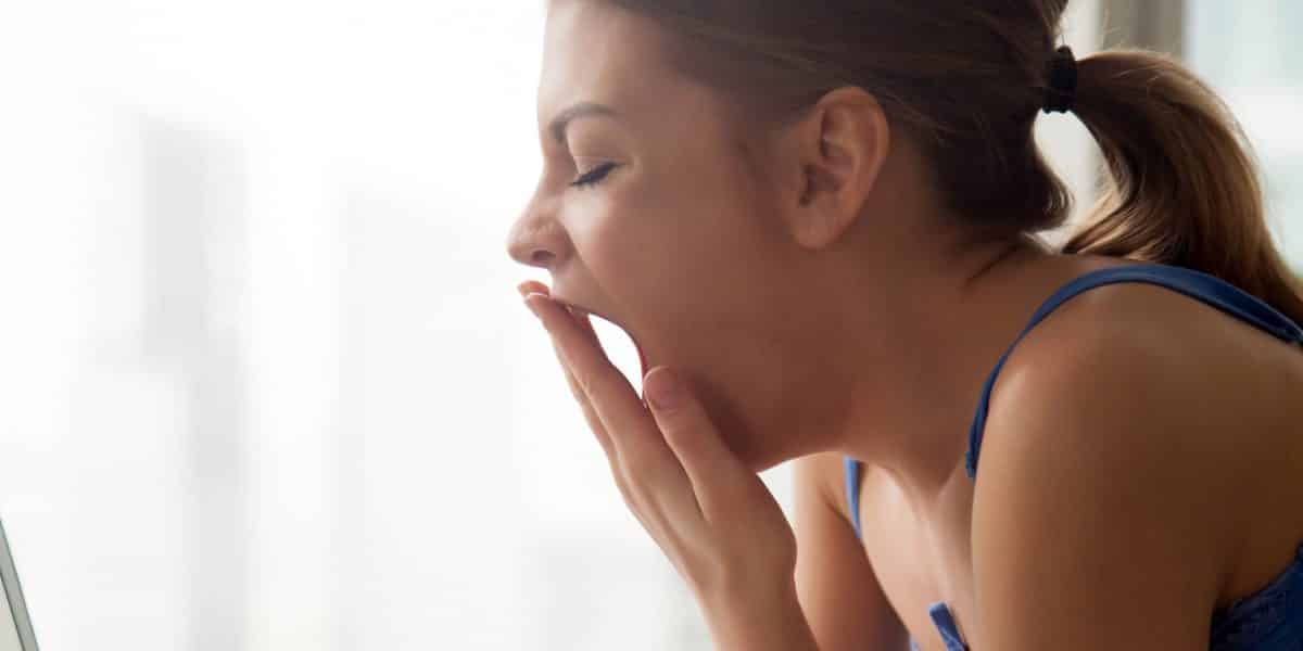 Woman struggling with insomnia yawning after taking too much Ambien
