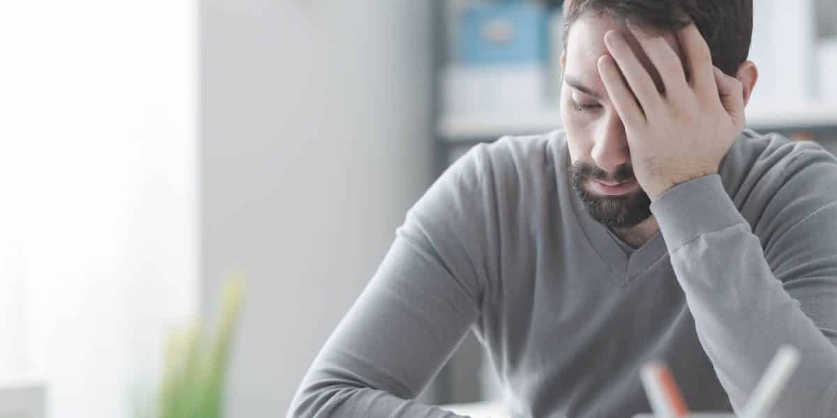 man with his hand on his forehead after taking too much Ativan