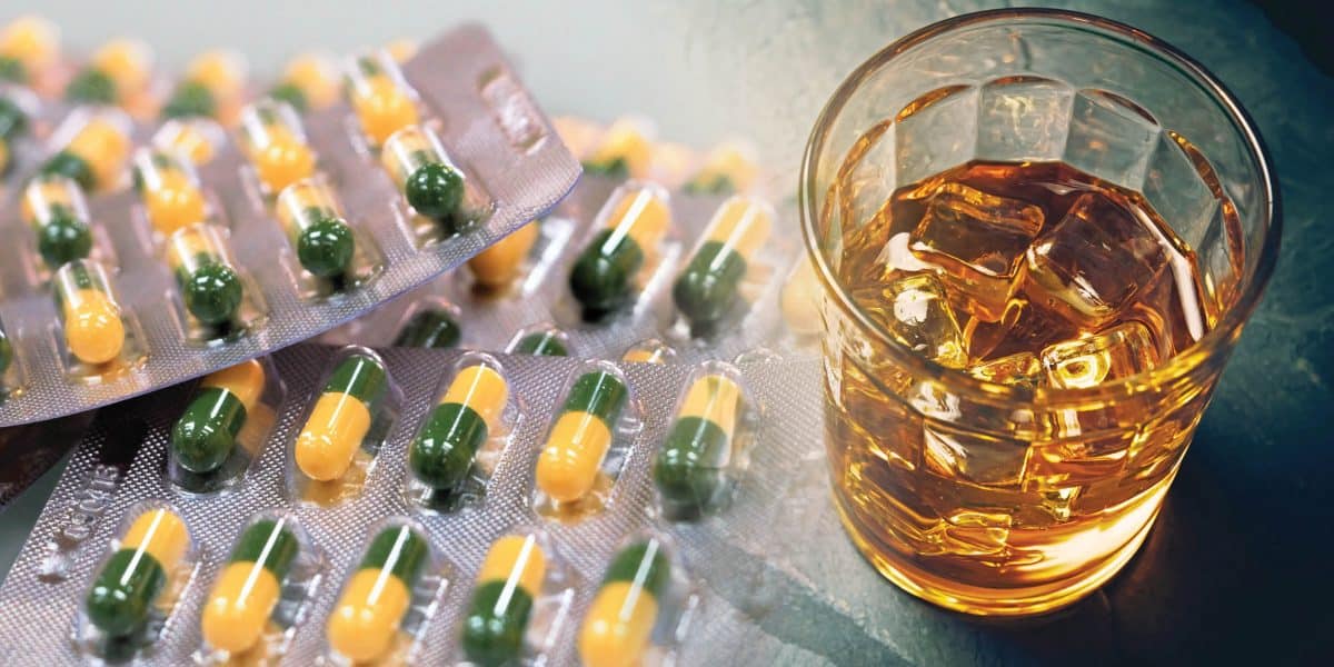 Librium pill packs next to drink on the rocks