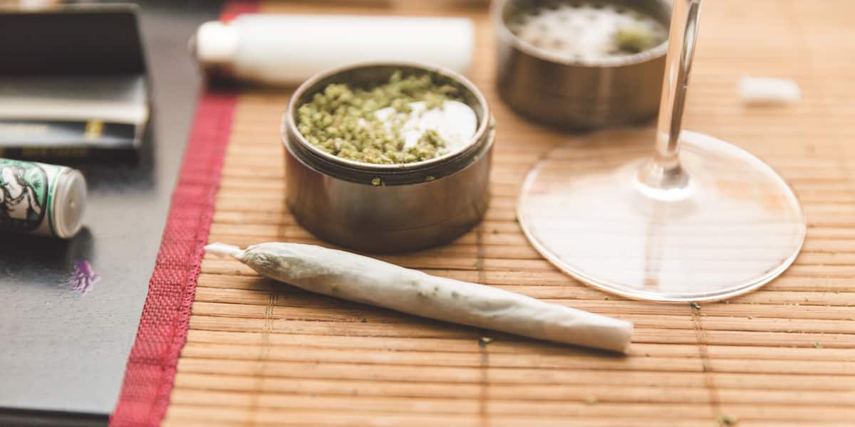 marijuana joint next to wine glass stem
