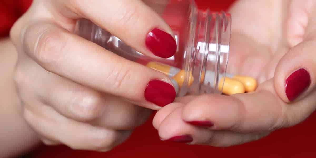 person pouring Ritalin capsules into their hand
