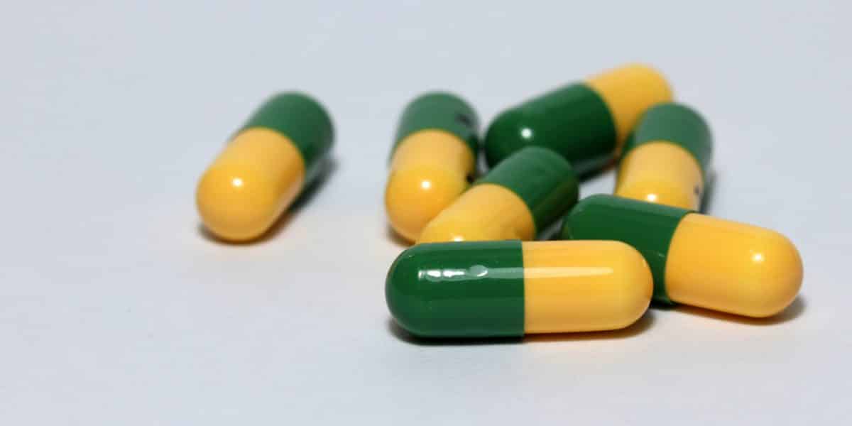 A small pile of green and yellow tramadol pills