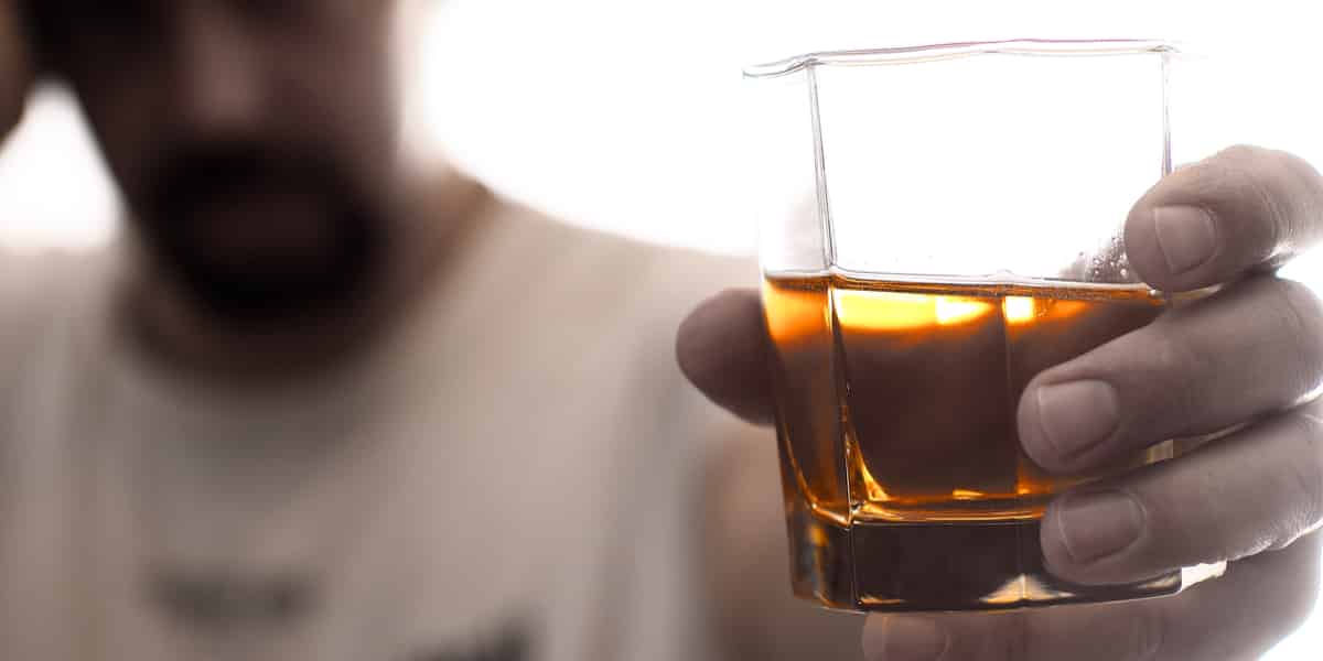 man on methadone holding an alcoholic drink