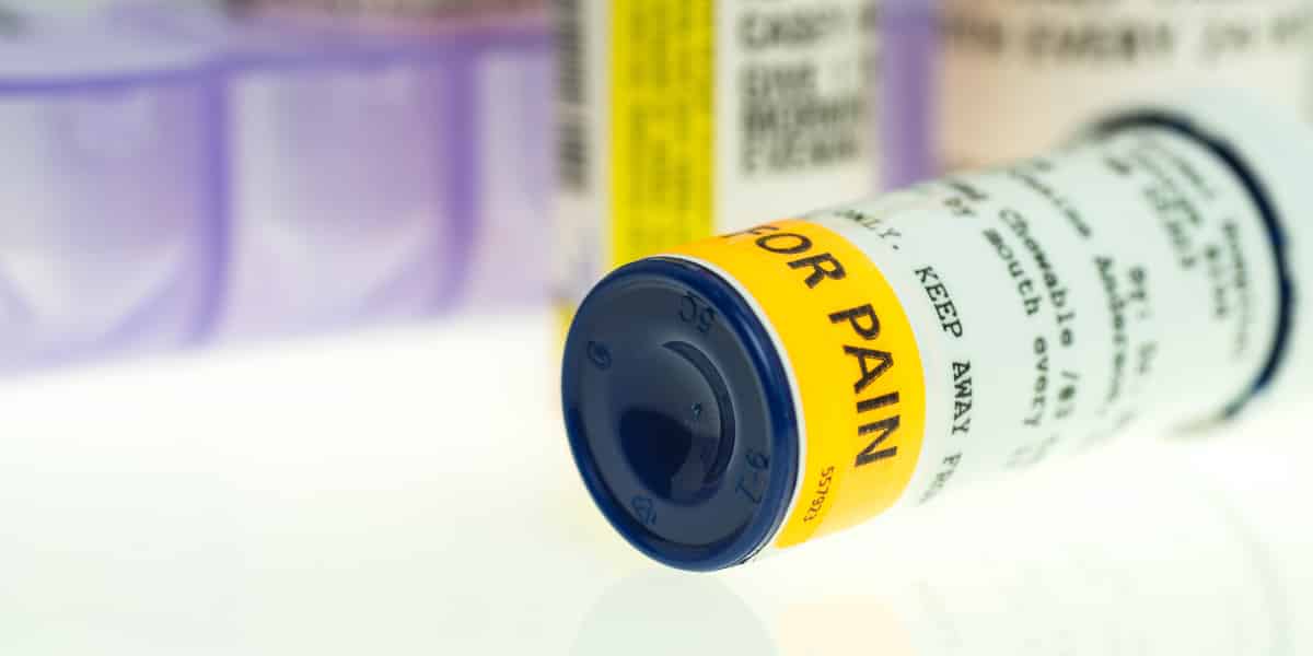 Prescription bottle of percocet fallen over on a counter