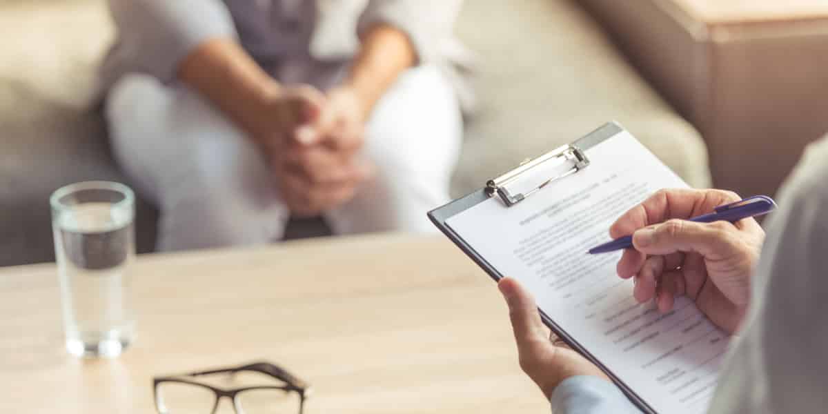 Person at a treatment facility going over their vicodin addiction treatment plan with a doctor