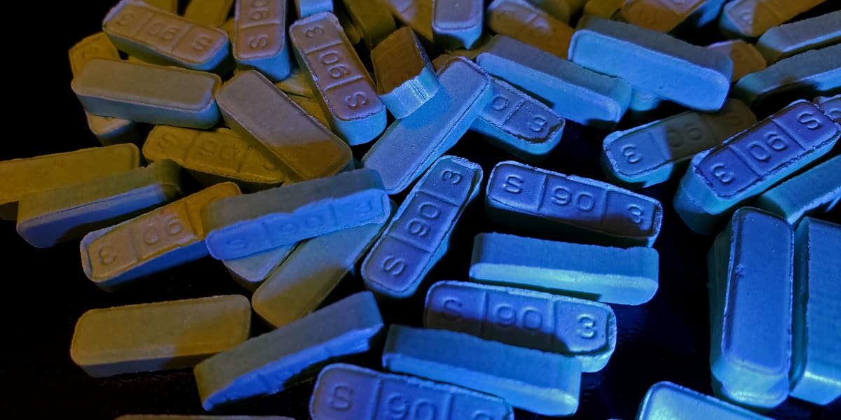Pile of blue xanax bars sitting on a counter