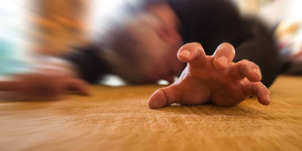 person collapsed on the floor after alcohol related seizure