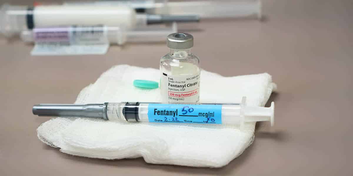 Vile and syringe of fentanyl sitting on a piece of gauze