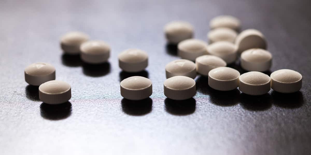 Opioids pills of a person tapering off of them spilled on a counter