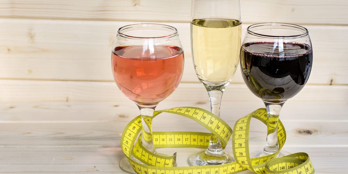 three glasses of wine surrounded by measuring tape