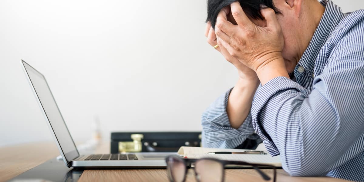 man appearing stressed at work