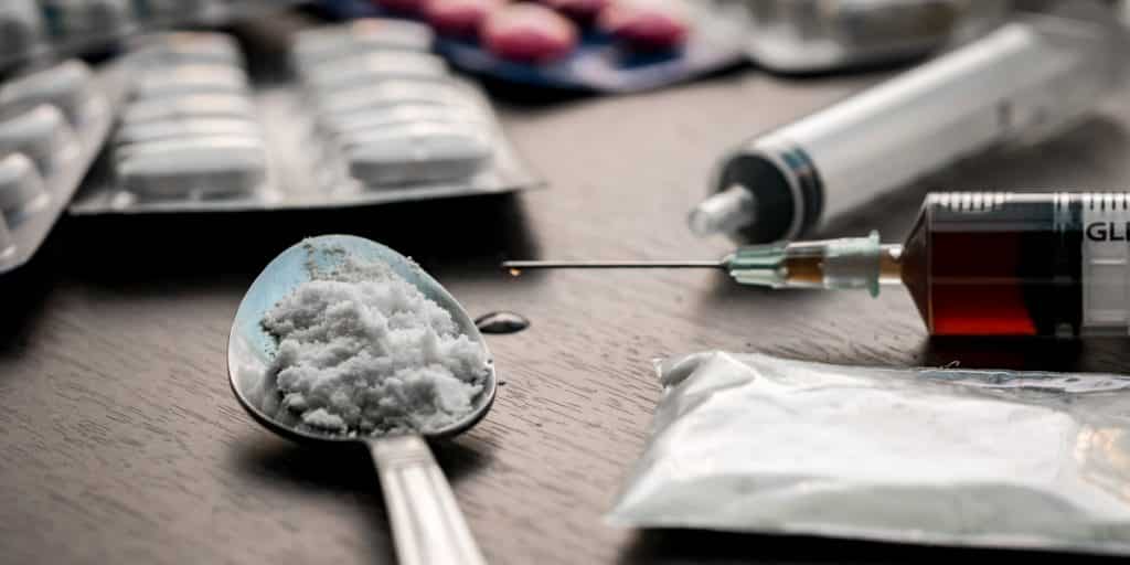 various drugs and paraphernalia on table