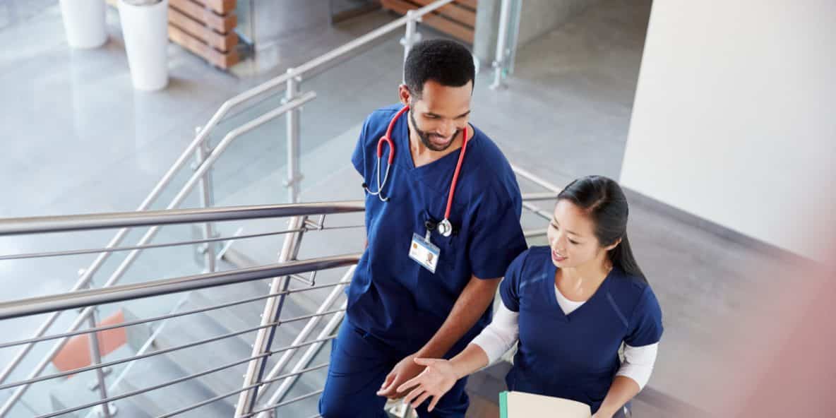 addiction healthcare workers talking while walking up the facility's stairs